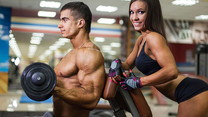 Bodybuilder and girl in the gym